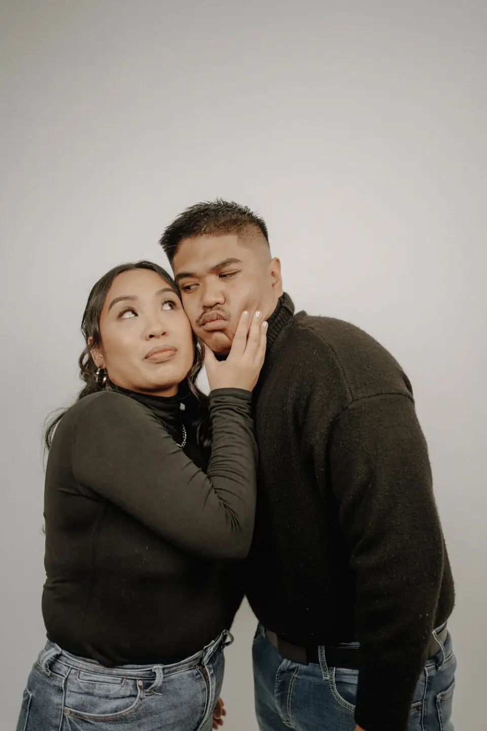 Playful close-up portrait of an engaged couple