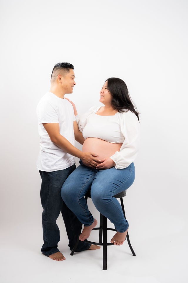 Expecting parents sharing a quiet moment in the studio