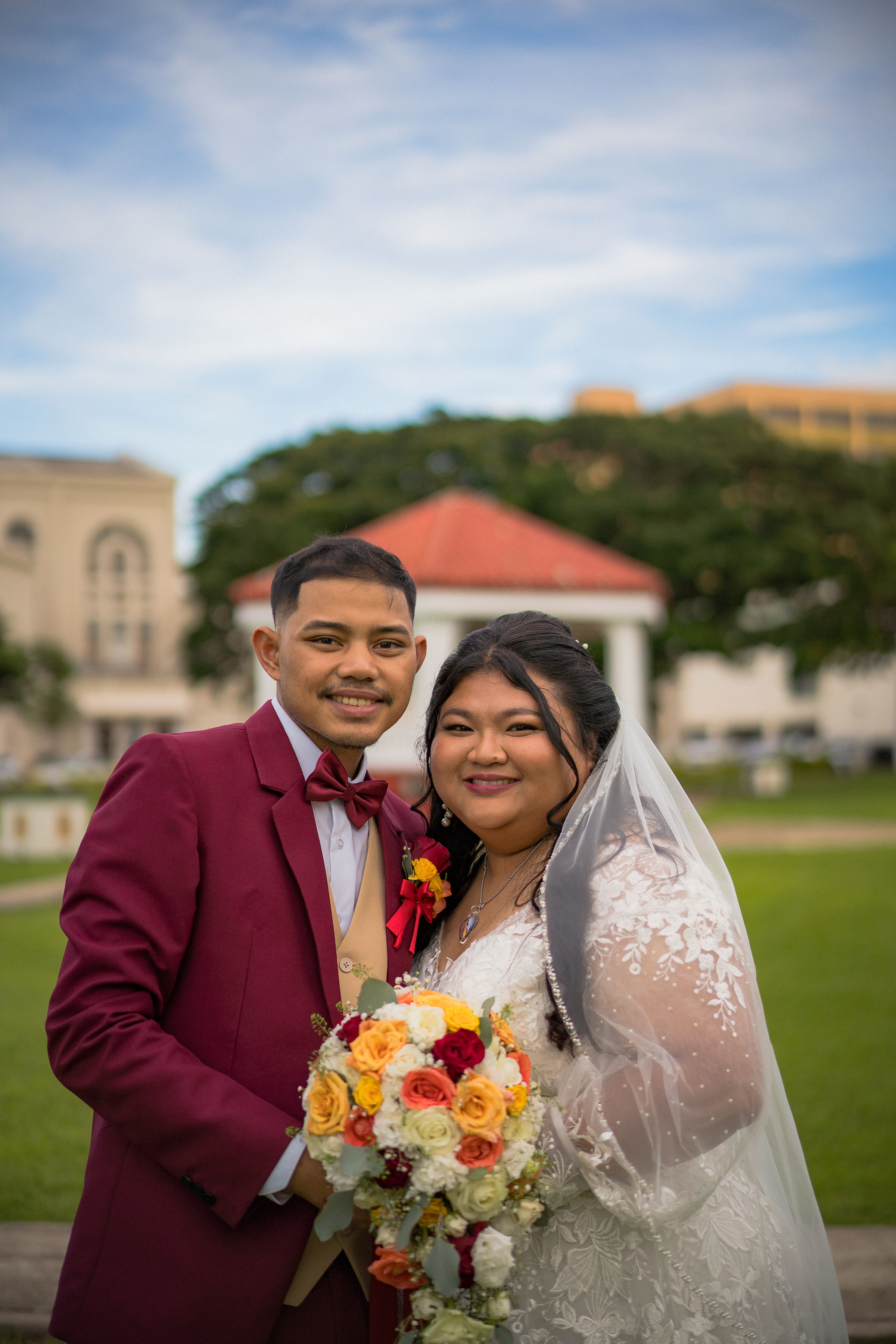 Thai and Don smiling together in their wedding attire