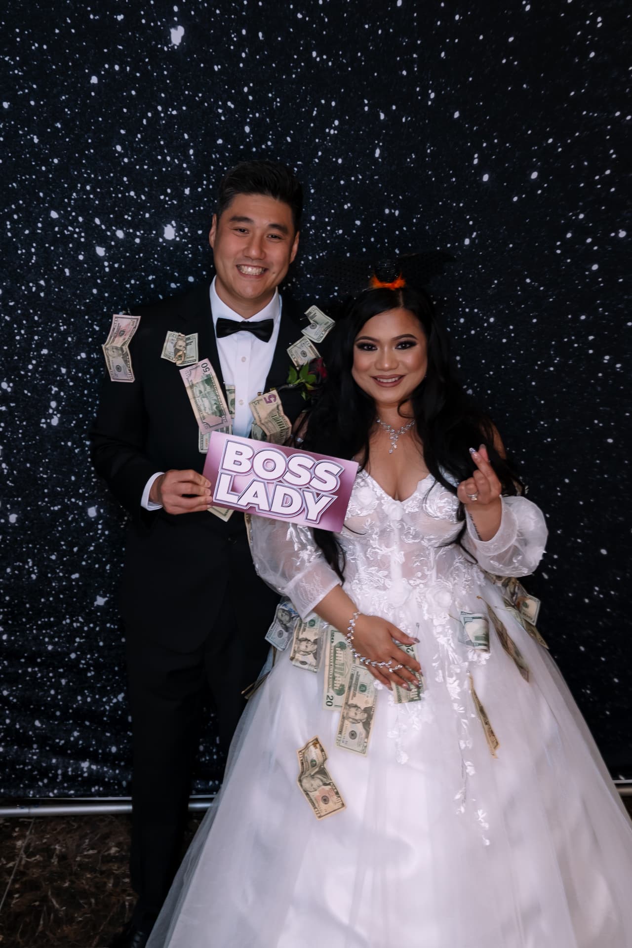 Couple with money dance props against a starry backdrop