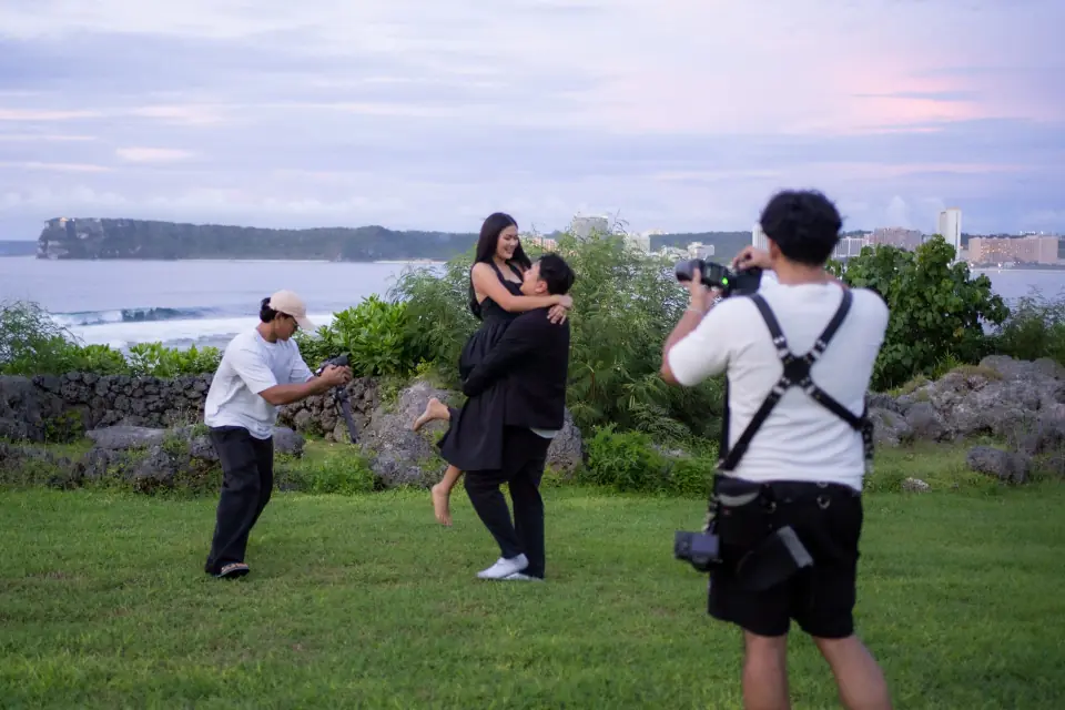 Stel Star photographer and filmmaker capturing a couple outdoors overlooking Guam's coast