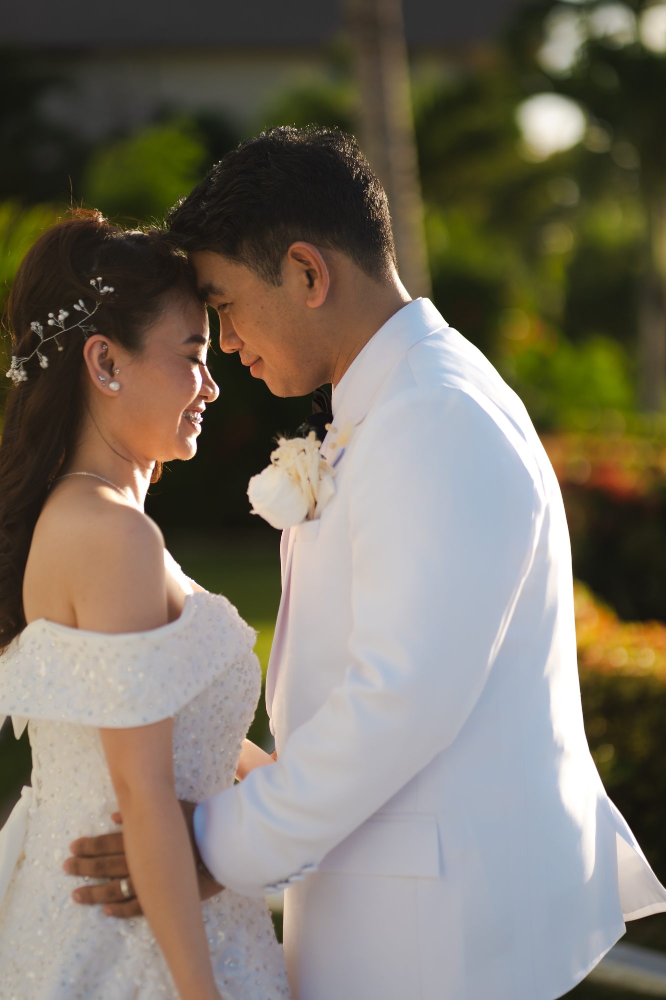 Couple portrait framed by island greenery