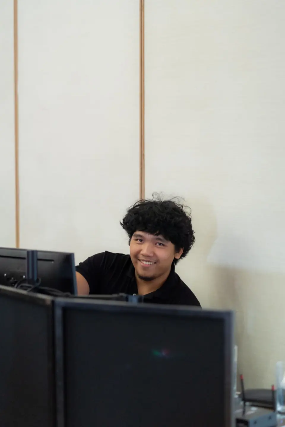 Stel Star team member smiling behind the monitors