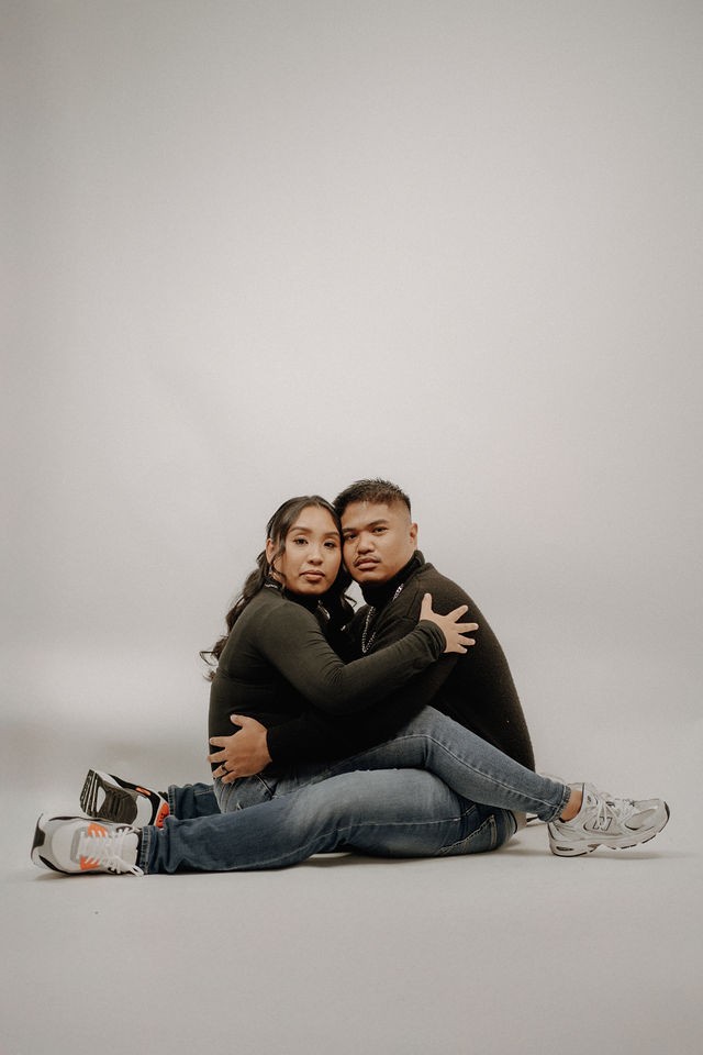 Relaxed couple pose during a modern studio portrait session